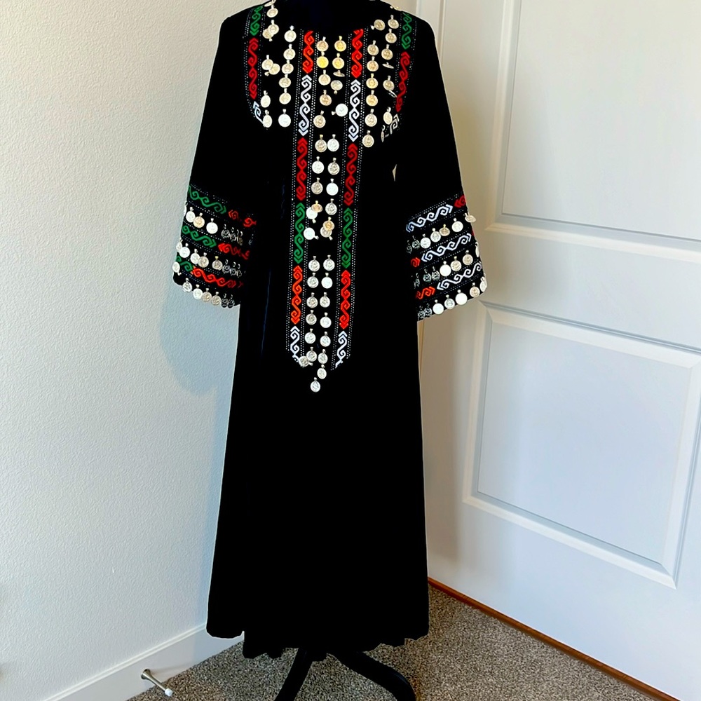 Long velvet dress in black color and designed with coins and ribbons